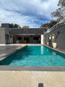 a swimming pool in the backyard of a house at Alefhouse in Bauru