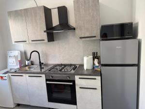 a kitchen with a stove and a refrigerator at Casa sissy in Chioggia +8 photos