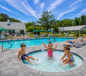 a group of children playing in a swimming pool at Brewster Green Resort in Brewster