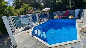 a swimming pool with a fence around it at Au Sable D'Or - Spa - WIfi- Piscine in Deshaies