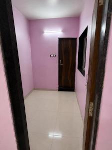 a hallway with pink walls and a door at Sunset View in Mahabaleshwar +16 photos