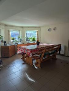 a kitchen with a table in the middle of a room at Vila lui Simion in Rimetea +11 photos