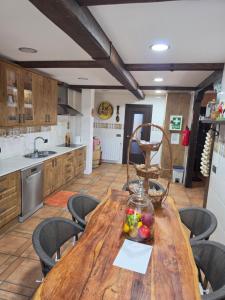 a kitchen with a wooden table with a bowl of fruit on it at Castillo Valmoral in Burgos