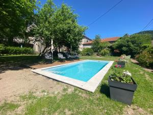 a swimming pool in the yard of a house at La petite chouette in Rochesson
