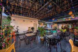 a restaurant with tables and chairs in a room at Cat Ba Vista Luxury Hotel - New 2026 - Rooftop Infinity Pool in Cat Ba