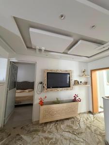 a living room with a flat screen tv on the ceiling at Lemjid house in Kelibia