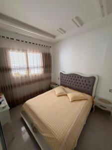 a bedroom with a bed and a window at Lemjid house in Kelibia
