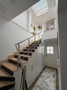 a staircase in a home with a skylight at Lemjid house in Kelibia