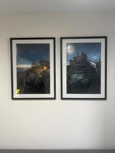 three framed pictures on a white wall at Apartament NOVA in Nowa Ruda +2 photos