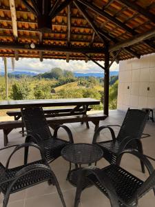 a patio with chairs and a table with a view at Cabanas Belvedere in Lauro Müller