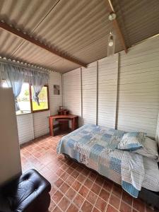 a bedroom with a bed and a table in a room at Cabaña de campo privada con piscina in Casa Blanca Hacienda +18 photos