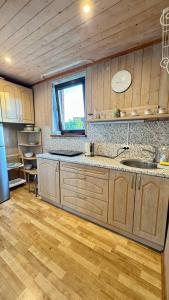 a kitchen with a sink and a counter top at На Видземском взморье Калнгале in Kalngale