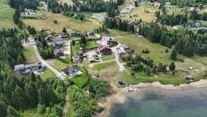 an aerial view of a house on a hill next to the water at Cabana Dany Colibița in Colibiţa +19 photos
