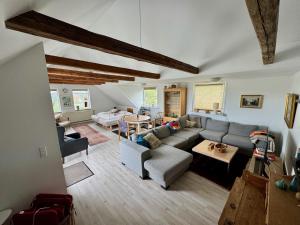 a living room with a couch and a table at Hostel Agger Vandrerhjem in Agger