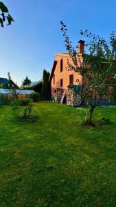 a large house in a grassy yard with a building at На Видземском взморье Калнгале in Kalngale +10 photos