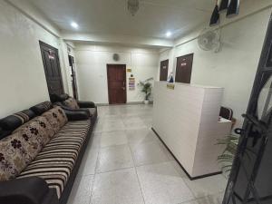 a waiting room with a couch in the middle of a room at Cloud Valley Inn in Cherrapunji +21 photos