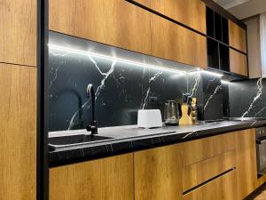 a kitchen with a sink and a counter at EKA Luxury Beachfront Apartments in Vlorë +145 photos