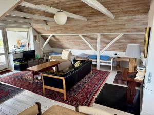 a living room with a couch and a table at Hostel Agger Vandrerhjem in Agger