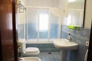 a bathroom with a toilet and a sink at La Calma Candás in Candás +50 photos