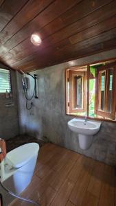 a bathroom with a sink and a toilet and a window at ฮักจังโฮมสเตย์ ที่พักแม่แตง in Chiang Mai +291 photos