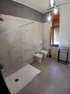 a bathroom with a shower and a toilet and a window at B&B Angelo Azzurro in Carpi +40 photos