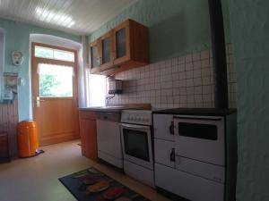 a kitchen with a white stove and a window at Forsthaus Castell in Castell +13 photos