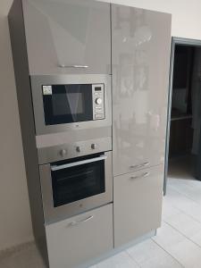 a stainless steel stove and refrigerator in a kitchen at B&B Angelo Azzurro in Carpi