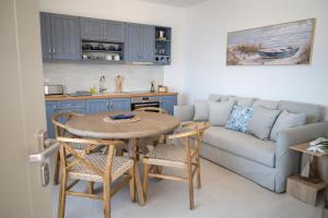 a kitchen and living room with a table and a couch at Vounara Houses in Artemonas