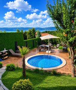 a pool in a yard with a table and chairs at Dilek Alagöz in Sapanca