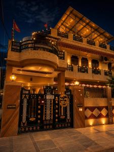 a building with a fence in front of it at night at Checkpoint Backpacker Jaipur in Jaipur