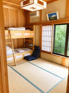 a room with bunk beds in a tiny house at STAY FUJI a in Yamanakako