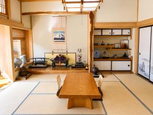 a large room with a wooden table and chairs at STAY FUJI a in Yamanakako