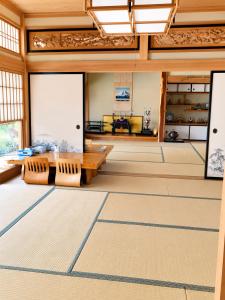 an empty room with a table and chairs in a building at STAY FUJI a in Yamanakako