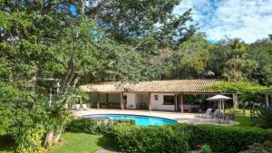 a villa with a swimming pool and a resort at Oratório Pousada Boutique in Tiradentes