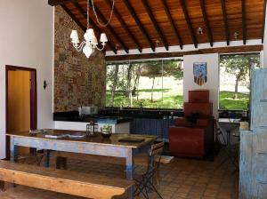 a dining room with a table and a bench at Oratório Pousada Boutique in Tiradentes