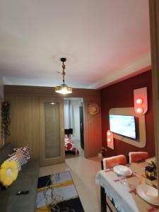 a living room with a table and a television at Shore residences tower D in Manila