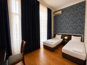 a hotel room with two beds and a window at Azcot Nizami Hotel in Baku +18 photos