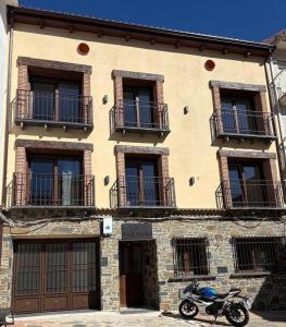a motorcycle parked in front of a building at Apartamentos Rurales La Estrella in Casar de Palomero