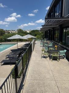 a patio with tables and chairs next to a pool at The Precinct Lifestyle in Midrand