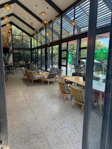 a dining room with tables and chairs and windows at The Precinct Lifestyle in Midrand