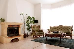 a living room with two chairs and a fireplace at La Calma Candás in Candás