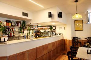 a bar in a restaurant with a counter and chairs at La Calma Candás in Candás