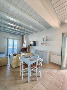 a kitchen and living room with a table and chairs at KLIMA apartment in Perdika