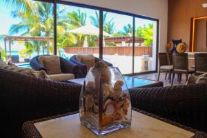 a glass vase with a stuffed animal on a table at Villa Siros de 4 habitaciones in Chicxulub