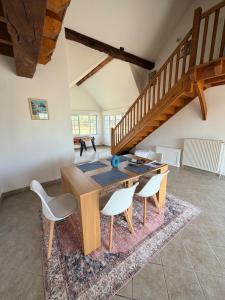 a dining room with a wooden table and chairs at Gite d'Aimelles in Billezois +14 photos