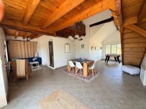 a large living room with a table and chairs at Gite d'Aimelles in Billezois