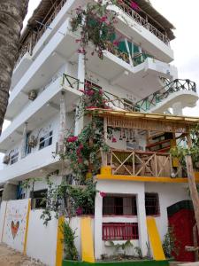 a building with flowers on the side of it at Nisandra Beach Hotel in Nungwi +24 photos