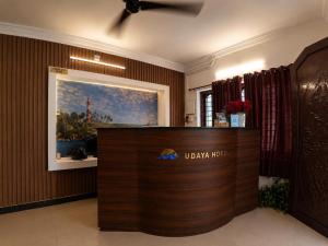 a lobby of a ukaja hotel with a reception desk at Udaya Hotel in Kovalam