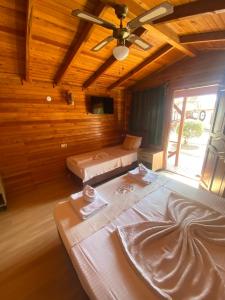 a room with two beds and a ceiling fan at Adrasan blue bay hotel in Kumluca