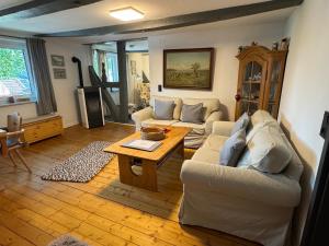 a living room with a couch and a table at Ferienwohnung Sonnentau 1 in Holzminden